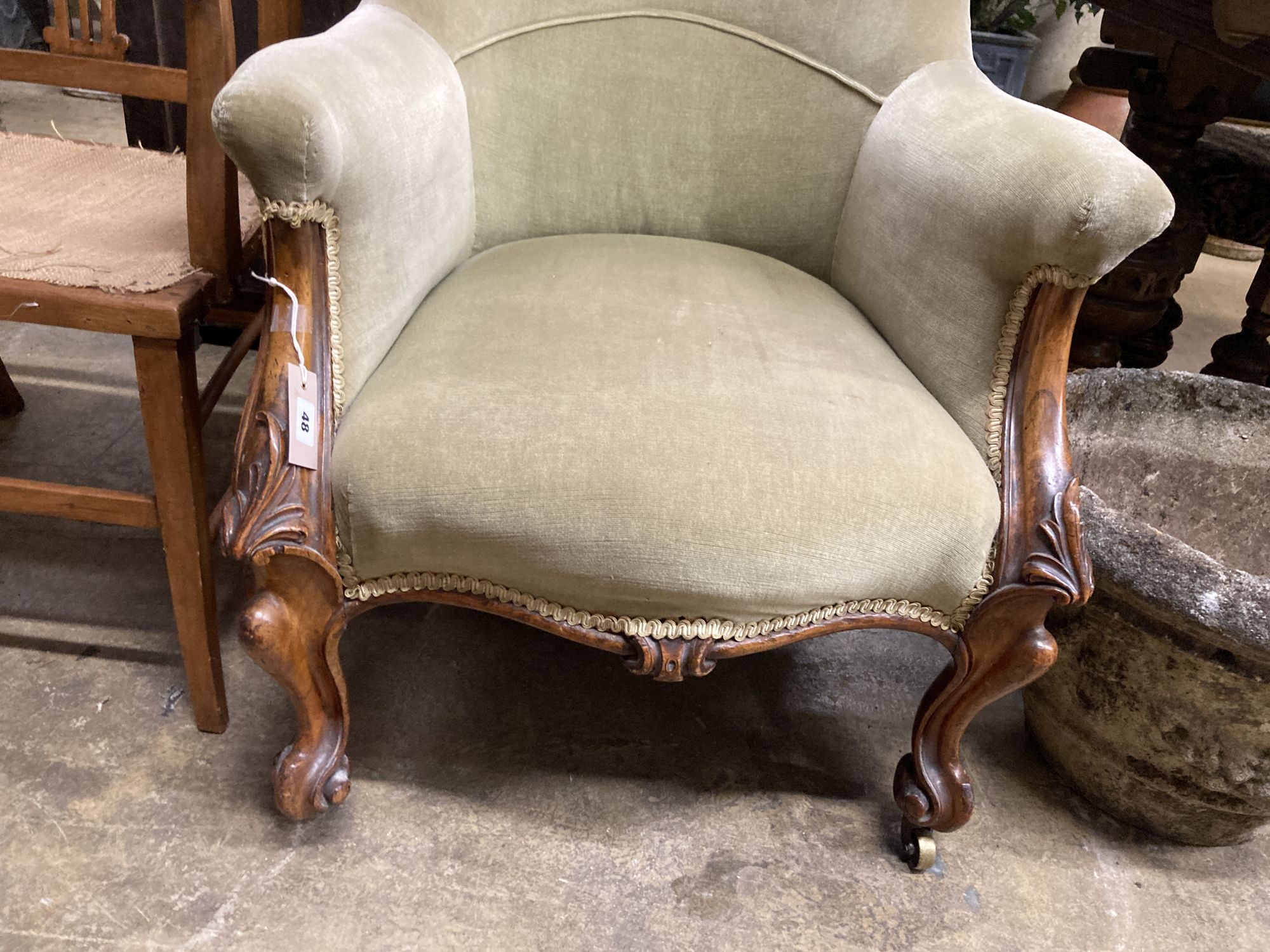 A Victorian walnut spoon back armchair, width 66cm, depth 84cm, height 84cm